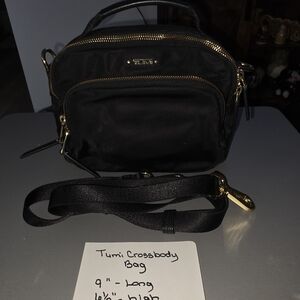Tumi brand black purse.